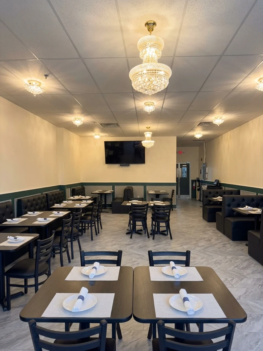 The dining room set for service, tables and booths under crystal chandeliers